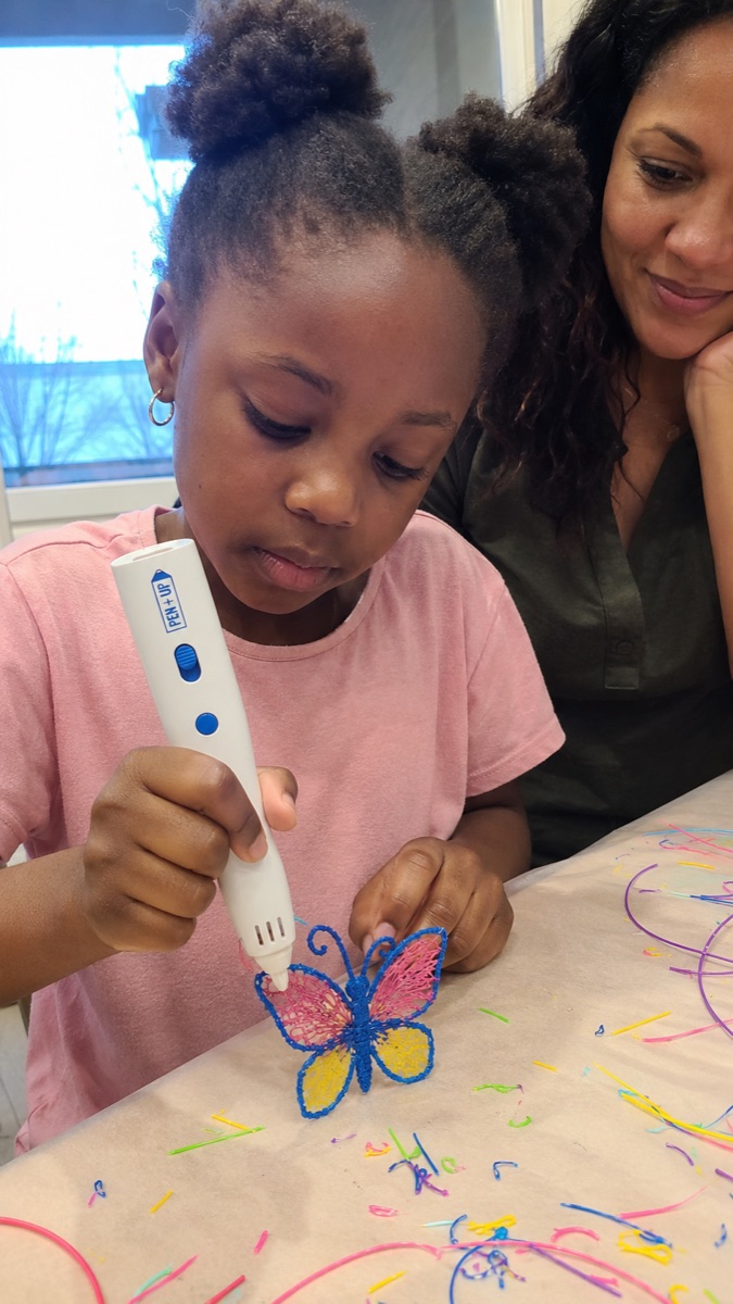 A parent and child creating together with the Pen'Up 3D pen